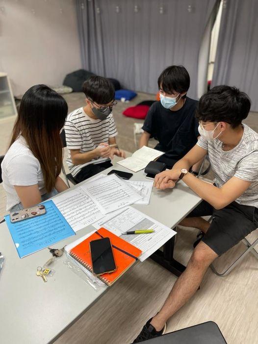 Members formed groups to discuss details of the performance.
