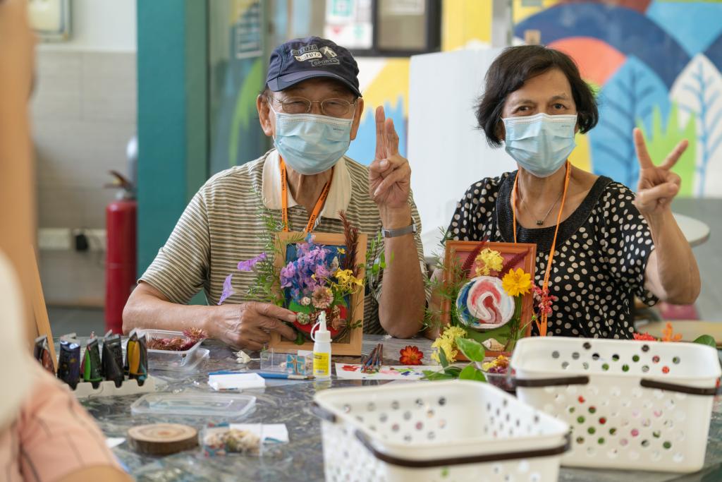 Chan (left) and his wife Ah Wah and their art pieces. Ah Wah agreed that the day camp facilitated communication between caregivers and patients.