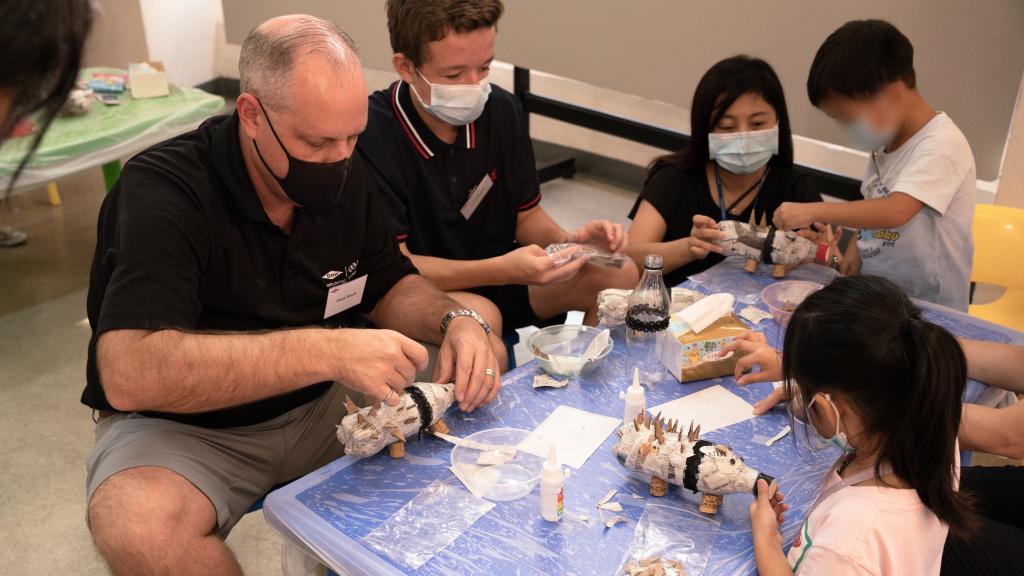 Children recycled plastic bottles into piggy banks, with the help of the volunteers.
