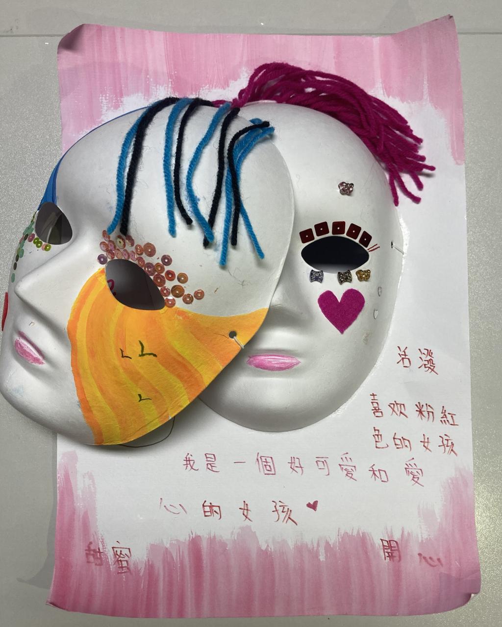 A painting with two masks on it.