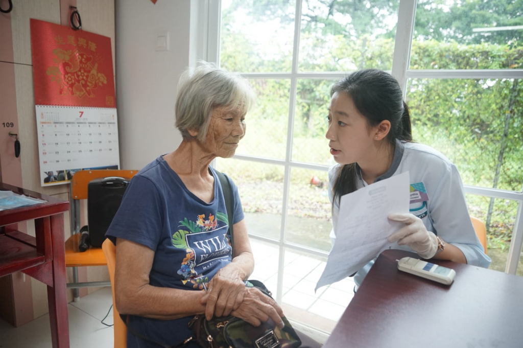 a female health consultant explains the data on the report to a female elderly