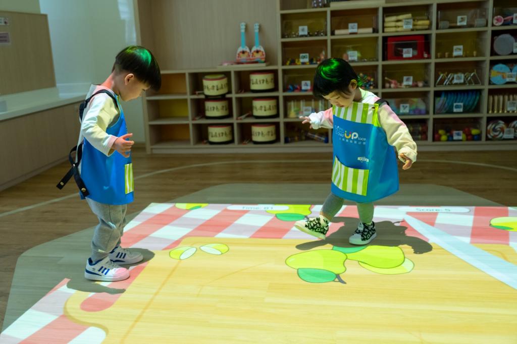 Two children playing with interactive projector games 