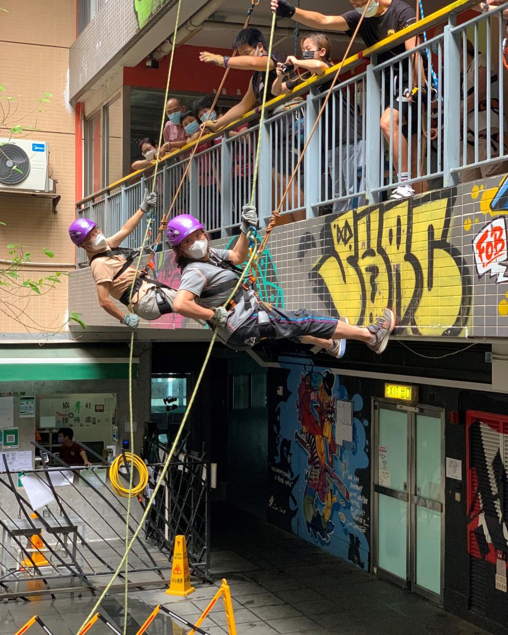 A pair of retired couple taking part in abseiling