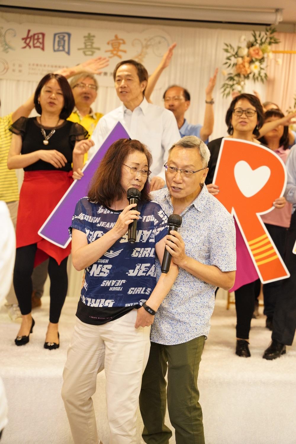 a pair of retired couples singing and dancing in front of a group of audience