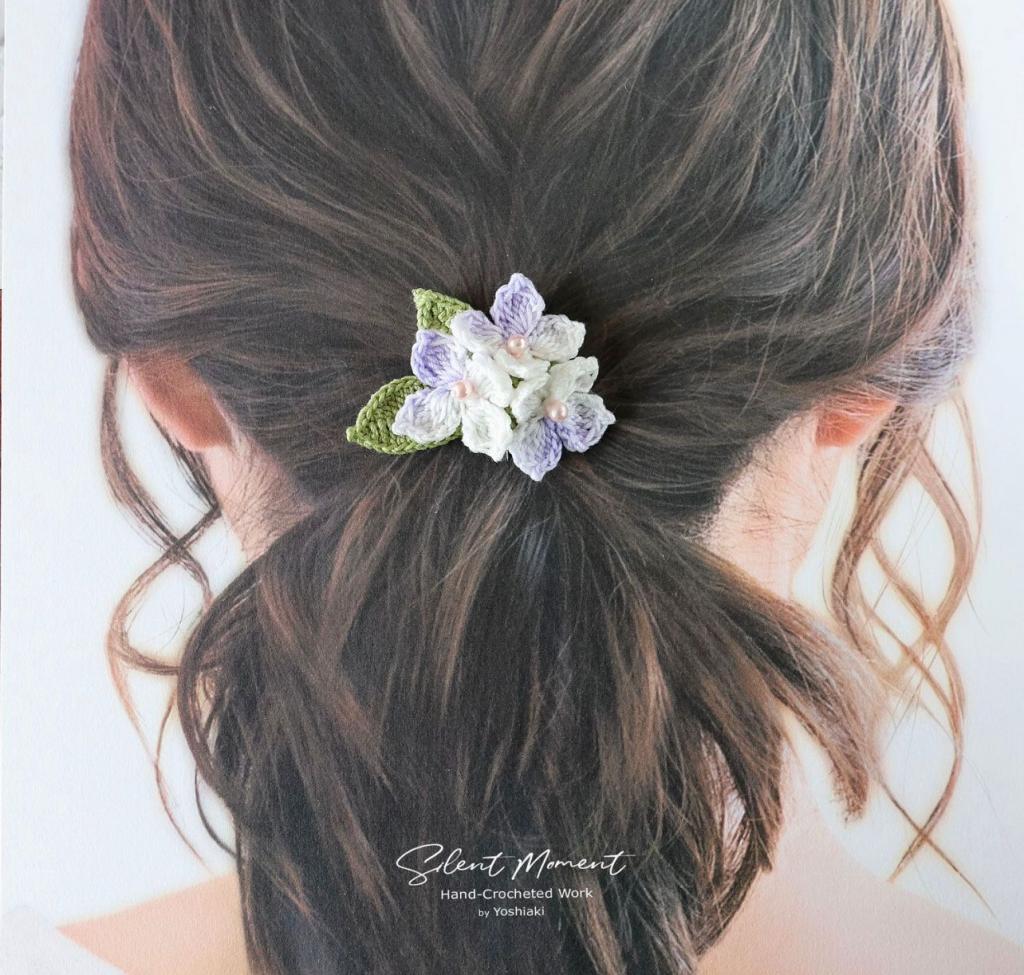 A lady wears a lilac scrunch. 