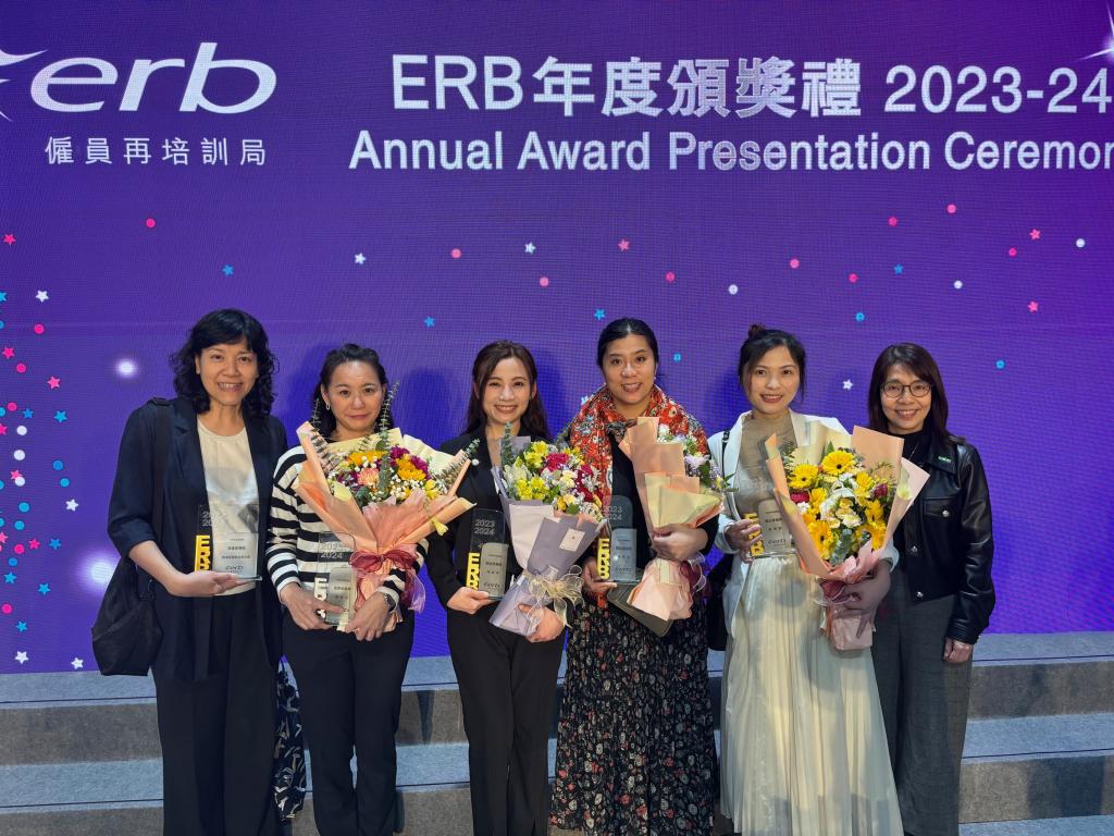 Six ladies took photo in front of the backdrop in the award presentation ceremony.