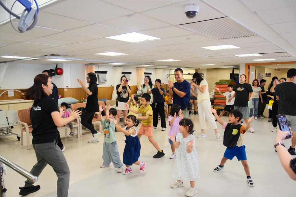 Parents and children engaged in playful interactions and strengthened their physical abilities in a fitness class.