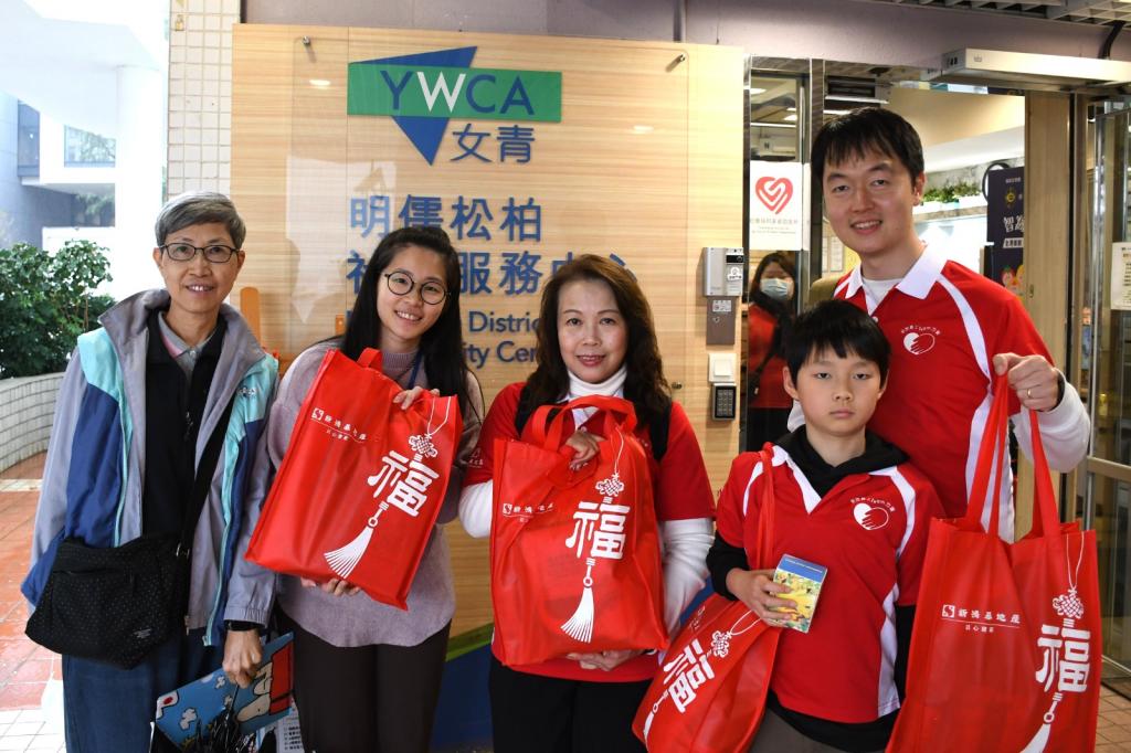 A spirited procession of volunteers, carrying heart-filled goodie bags, prepared to set off for the home visits.