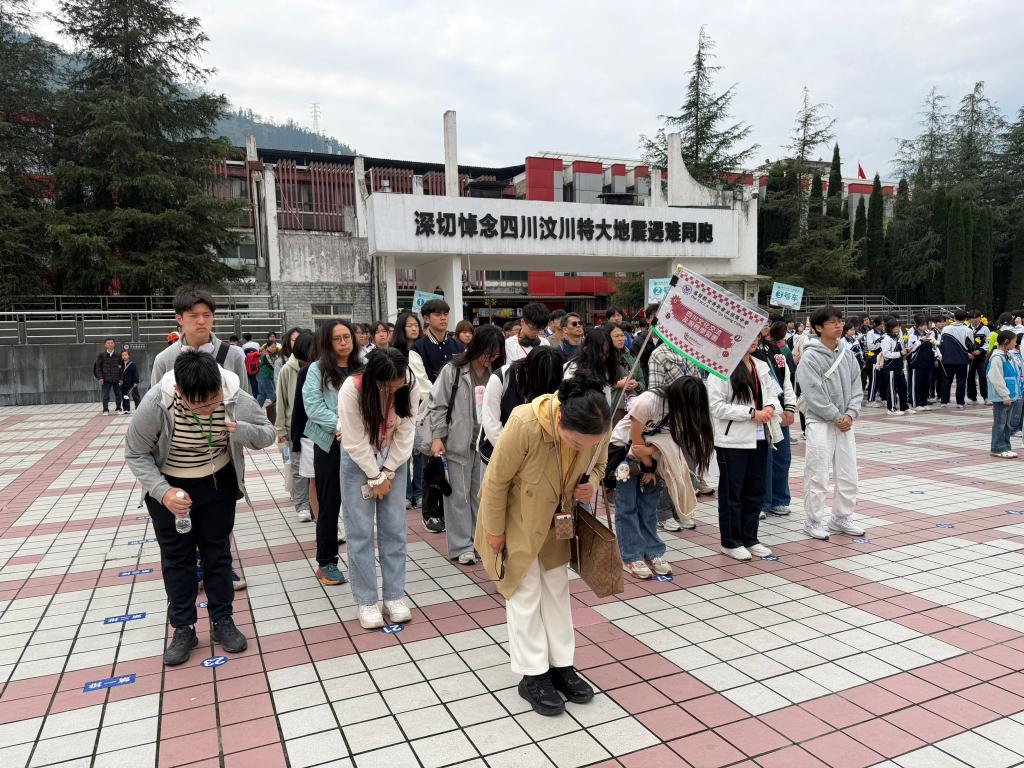 At the Yingxiu Epicenter Memorial Hall of the 5.12 Wenchuan Earthquake, students spontaneously stood in solemn silence and presented flowers to mourn the victims. 