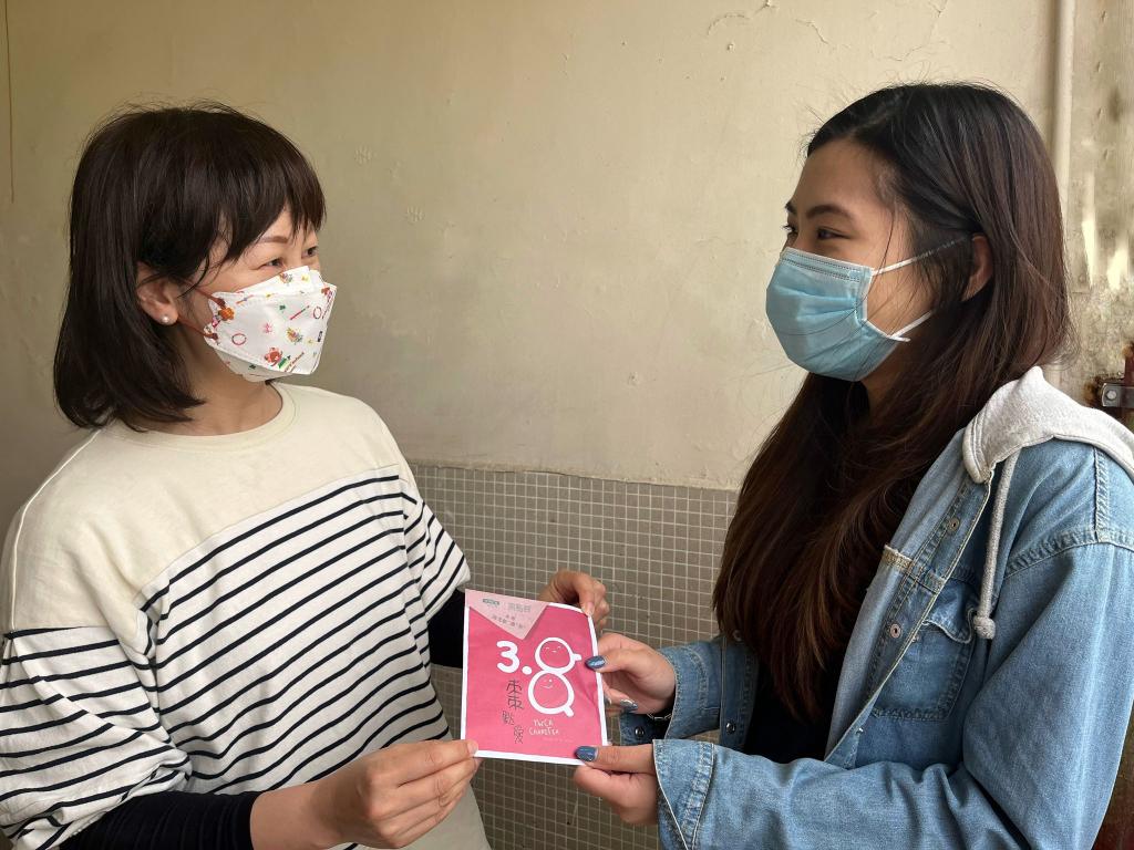 右方的女士將茶包交給左方的女士